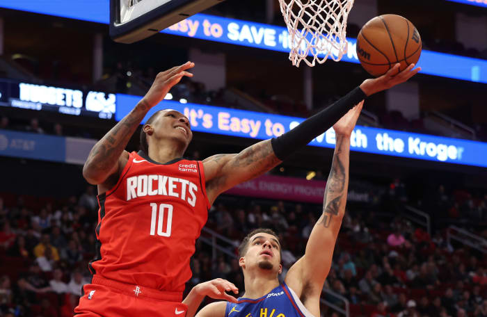 Rockets forward Jabari Smith Jr. (10) scores against Denver Nuggets forward Michael Porter Jr. (1) in the second quarter at Toyota Center.